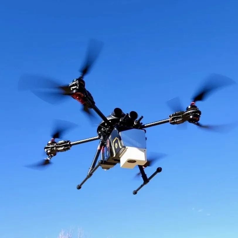 Hyperspectral sensor drone in flight against a blue sky